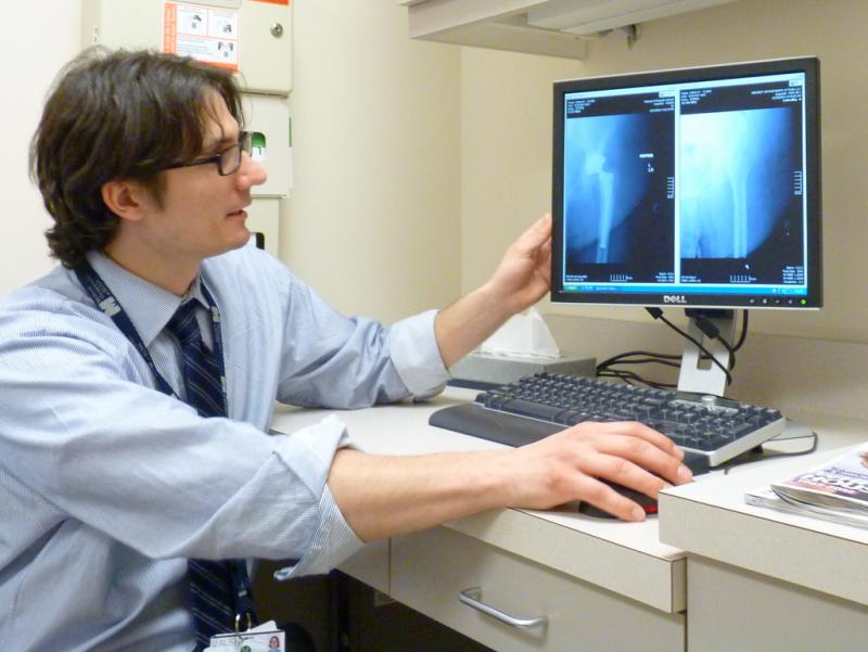 Physician looking at X-ray images Doctor viewing X-ray images